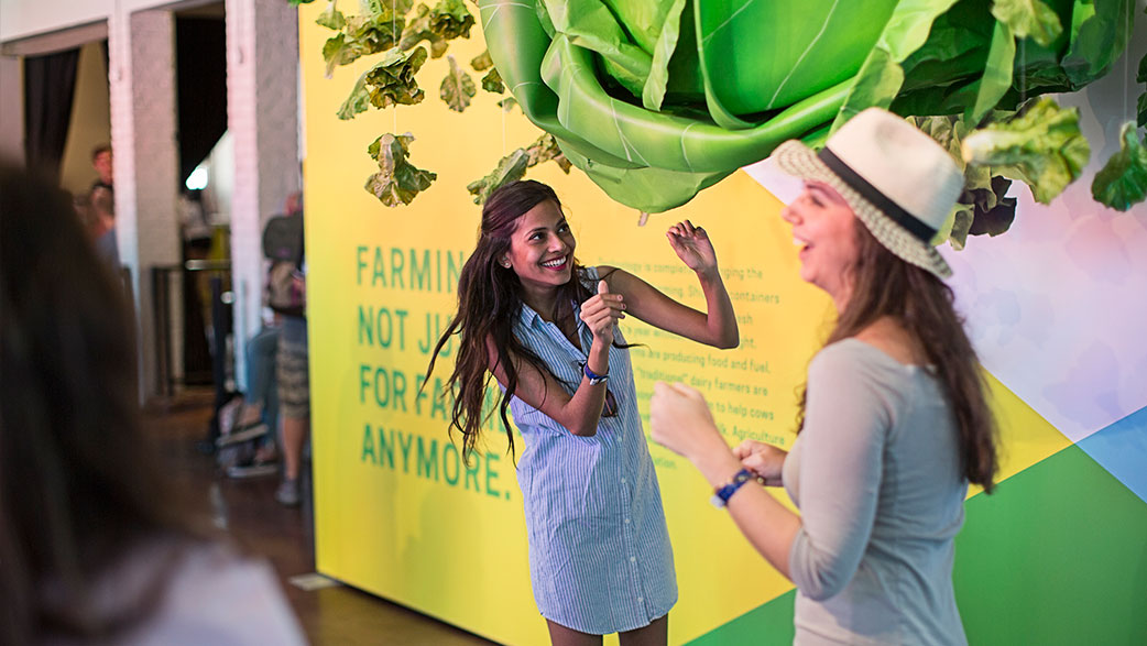 A Woman Approaching The Giant Head Of Lettuce At South By Southwest's The Food Effect