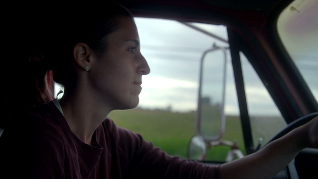 A Female Farmer Driving A Truck